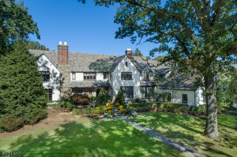 Architectural masterpiece BEAUTIFULLY RENOVATED from top to bottom in the heart of Old Short Hills' prestigious Woodfield Estates. Featured in Millburn & Short Hills Magazine! This 6 BD, 4 Full 2 Half BA Tudor style home combines exquisite details such as wide plank hardwood floors, plaster walls w/bas relief motif, beamed ceilings & leaded glass windows, all flowing seamlessly through original & newer parts of the home. Fab LVR w/limestone & carved wood fireplace, beamed ceiling, raised panel moldings & original custom built-ins. Dreamy Sun Rm opening up to stunning entertaining Patio w/ Summer Kitchen & magnificent 3/4 acre of private grounds w/ room for a Pool. Gracious DR. A Gourmet Chef's Kitchen w/custom Wood Mode cabinetry, an oversized island, soapstone/limestone/butcher block countertops and high-end Viking/Dacor/Sub-Zero appliances. Magical Breakfast Rm overlooking garden. Gorgeous FR w/ floor to ceiling stone FP & beamed ceiling, plaster walls and leaded glass windows mimicking original details of the home. Sunny and Zen Primary Bedroom Suite w/ Cali Closets, Dressing Rm, additional custom closets and a spa-like bath. All other BDs & BAs are outstanding. 2nd Lvl Laundry. Lower Level w/ huge Rec Rm, Game Area, Built In Wet Bar, Exercise Rm, Full BA and a ton of storage spaces (plenty of room for Wine Cellar).  Lower taxes than comparable Old Short Hills homes!  Just mins from downtown Millburn, Blue Ribbon Schools & NYC Train. This home must be seen to be believed!