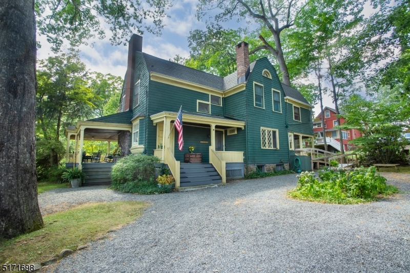Built in 1898, for J.W. Cleveland Esq., this classic Victorian home is the crown jewel of Mt. Tabor, a quiet historic community in the hills of Parsippany.  Whether you need to store your classic car or lawn tools, bikes and sleds, Mt Tabor's first-built, detached garage has plenty of room for your needs.  With two driveways affording parking for up to 9 vehicles, there is plenty of room!Enjoy the endless cool summer breezes while you entertain on any one of the 3 lower porches or sit with a loved one on the balcony off of the primary bedroom.  This gem is centrally located atop Mt. Tabor and it's a chip shot away from a beautiful 9-hole private country club.  You'll also find it a short to walk to the basketball court, playgrounds, a fishing pond, and the tabernacle.  Walk to the local elementary school, or the Mt. Tabor train station. This 5 bedroom, 2.5 bath home sits on .049 acre. The first floor has an eat-in kitchen with a true butler's pantry. The pantry is adjacent to the dining room where you will find a decorative venetian ceiling and wide moldings. The living room centerpiece is its original fireplace with brick hearth and mantel, and the dutch door accessing one of the spacious open porches. Another architectural highlight of this home is the gambrel roof and turn of the century shingle style exterior.  Thirty-five Ridgewood Avenue awaits its fourth owners who will surely make lifelong memories in a home, (and town) truly like no other.