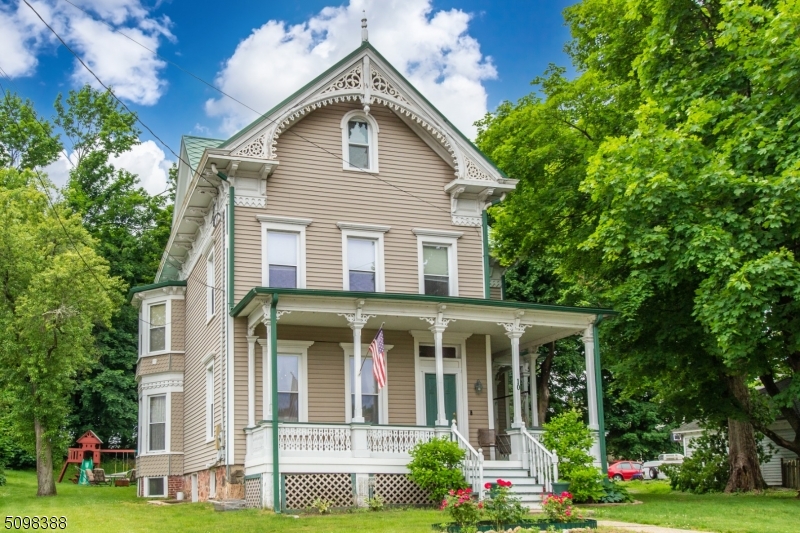 This beautiful Victorian with classic details and modern updates has hardwood floors and high ceilings throughout, two-unit central AC, natural gas heat, and public utilities. The main level has a wonderfully updated kitchen with an island and stainless appliances, a "maid's quarters" stairway to one of the bedrooms, a dining room with pocket doors, an office with a half bath, decorative fireplaces, and a composite front porch with wood details. The second level has a master bedroom with walk-in closet, bath with washer/dryer, bath with clawfoot tub, and two additional bedrooms. The third level is a walk-up finished attic with bedroom and full bath, and the basement has a workshop and rec area with a wet bar. The metal roof adds character and durability. Home warranty included. Netcong is a walkable town close to commuter routes, NJ Transit train, and Lake Musconetcong with a public boat launch.