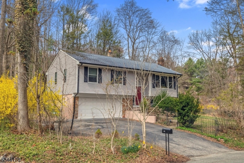 So many upgrades - recessed lighting throughout, new vinyl siding, new gutters, grill deck with direct gas line, new screened porch with vaulted ceiling and ceiling fan, new windows and sliding door on main level, laundry room updated, newer kitchen appliances, natural gas boiler 2 years old, updated plumbing and electrical, newer ceiling fans, and more! Move right in and enjoy - kitchen offers stainless appliances, granite countertops, spacious bedrooms, hardwood flooring, lower level family room with woodburning fireplace and full bath. Playset included; Fireplace as-is; Located in a highly ranked school district, just minutes to Rt. 23, close to shopping and dining.