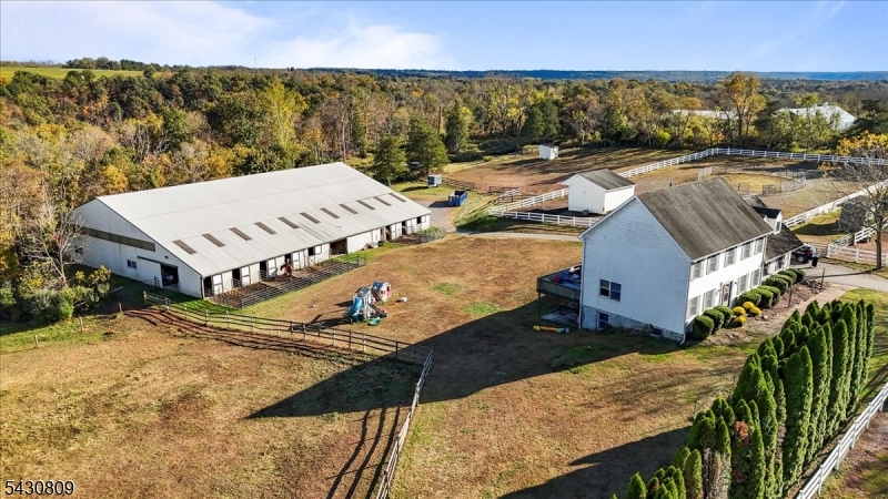 Well-appointed horse farm set on nearly 12 acres, featuring a 7-stall barn and a 70' x 120' indoor riding arena, ideal for year-round training and riding. The barn is equipped with a heated tack room with bathroom and laundry, along with a hot/cold wash stall for added convenience. Electric and water service to all pastures support efficient daily care and ease of management. Enjoy scenic trail riding throughout the property, with trails winding down to a peaceful creek perfect for conditioning rides or leisurely hacks. A thoughtfully designed equestrian property offering both functionality and versatility, ideal for training, boarding, or private equestrian use. The property features a 4-bedroom, 3.5-bath colonial home with new laminate flooring and fresh paint throughout (2021). The fully finished walkout basement provides additional living space and a full bathroom. This dream country retreat is just minutes from the charming river town of Frenchtown, known for its sought after schools, quaint shops and highly rated local favorite dining. The farmland assessment application has been submitted by the current owners, tax break to go into effect in 2027, new buyer to coordinate permanent plan with tax assessor.