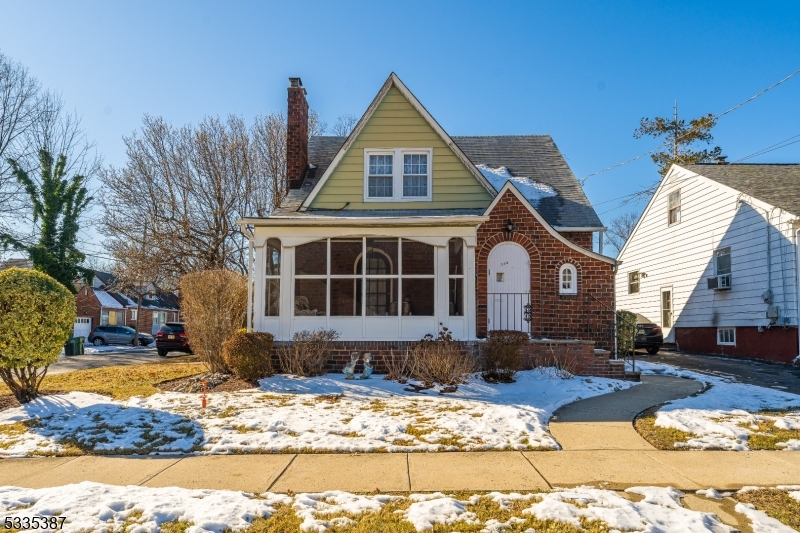 Discover the charm of this delightful 2-bedroom, 1-bathroom Tudor-style home, just minutes from the scenic Warinanco Park. Featuring a classic brick and siding exterior, an inviting arched entryway, and a screened-in front porch, this home exudes character and warmth. Step inside to find spacious rooms with original hardwood floors, sloped ceilings, and large windows that fill the space with natural light. The living and dining areas offer a cozy yet open feel, with arched doorways and vintage details adding to the home's charm. The kitchen, with its classic wooden cabinetry, provides a functional layout and a great opportunity for customization. Upstairs, two generously sized bedrooms offer comfort and character, while the full bath retains its vintage appeal with unique tilework and a pastel sink. Outside, the fenced backyard includes a detached garage and private driveway, offering ample parking. Conveniently located near shopping, schools, and major highways, this home is a fantastic opportunity to create your dream space while preserving its historic character. With Warinanco Park just a short walk away, you'll enjoy easy access to beautiful trails, recreational facilities, and year-round activities. Schedule a showing today!
