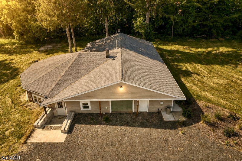 Set on a full acre in scenic White Township, this earth sheltered 4 bedroom, 2 bath ranch is one of the smartest built homes you'll find in Warren County. This Earth Home aka Berm construction means natural insulation year round, staying cool in summer, warm in winter, and remarkably quiet, with energy costs most homes simply can't match. Natural gas adds even more value, a rare find in this rural setting that keeps heating reliable and affordable. Inside, the open concept living space surprises with vaulted ceilings and exposed wood beams, brightened by recessed lighting and luxury vinyl plank flooring throughout. The updated kitchen features stainless steel appliances, while the primary suite offers a private full bath and walk in closet, plus three more generously sized bedrooms for guests, a home office, or room to grow. Out back, a huge yard invites gardens, gatherings, or simply space to breathe, all minutes from Route 46. Efficient, distinctive, and built to last.
