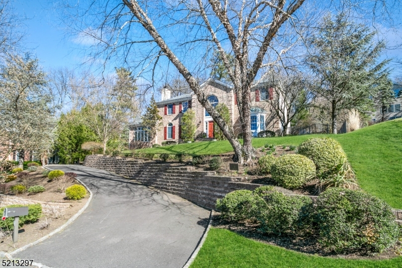 Prestigious home nestled atop professionally landscaped grounds in a desirable cul-de-sac location! Sophisticated open floor plan boasts spacious, sun-filled rooms w/designer finishing touches, sprawling hardwood floors, oversized windows. 2-story foyer w/sweeping curved stairs. Living room w/modern fireplace & tall arched windows. Conservatory w/walls of floor-to-ceiling windows. Office w/double French doors. Dining room w/tray ceiling, dazzling chandelier, & bay window. Open-concept family room & kitchen w/abundant natural light, & serene views. Family room w/handsome fireplace & wall of floor-to-ceiling windows. Gourmet kitchen with accented cabinetry, high-end appls, granite counters, & large size center island. Designer powder room. Spacious Master bedroom w/sitting room & well-appointed ensuite bath. 2 bedrooms share Jack-&-Jill bath; 4th bedroom w/ensuite bath. Beautiful finished basement w/5th bedroom & full bath. Close proximity to NY trains, award winning Chatham schools, shopping, restaurants and major highways!