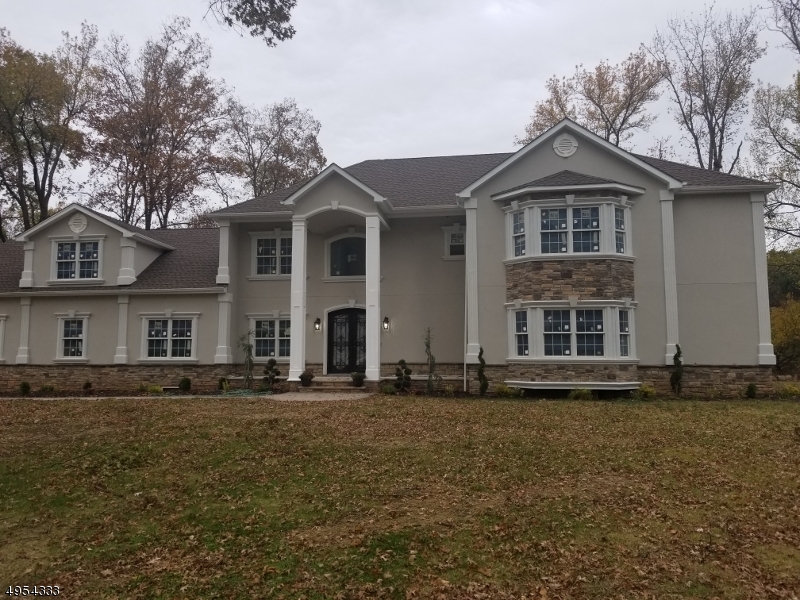 Magnificent, completely rebuilt from studs up.. Grand Colonial in quiet, private neighborhood. Multi Generational living at its finest. Master Suite options on 1st or second floors. Quartz counters and glistening stone floors in Kitchen and lower level. stainless steel appliances. Hardwood floors. No expense was spared in the creation of this grand estate house. Everything new. New sewer line, water line, electric panel and sub panel.This is a Smart house. Completely prewired for internet, phone, sound system, nest thermostat and 15 exterior Ring security camera system included.