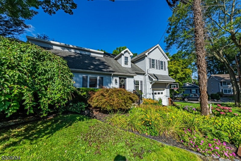 True Pride of ownership in this custom and charming home! Beautiful hardwood flooring. Lovely Architectural Features throughout, gives this Home a Lake Cottage Feel! Stunning kitchen with breakfast bar, pantry and stainless steel appliances. Open dining area and a bright, large living room with multiple windows and tons of natural light. Laundry/mudroom with sloop sink and indoor garage access. Convenient first floor bedroom and full bath. Upstairs, a primary bedroom offers an en-suite bath. 2nd bedroom and an office. Generous loft space. This floor can be accessed by either a spiral or traditional staircase. Neutral colors throughout. Super-sized garage has high ceilings. Corner property, beautifully landscaped front & private back area with wood fence and deck. Tremendous curb appeal! Full house natural gas generator, dual AC & furnace. Downstairs ac condensor brand new. Enjoy all that Indian Lake has to offer. Fantastic location; walking distance to Indian Lake Bistro, ILCC Clubhouse, beaches, swimming, boating, playground & fun! Mins from DWTN Denville, NYC commuter locations for both bus & trains. Top Schools! House has been meticulously maintained.