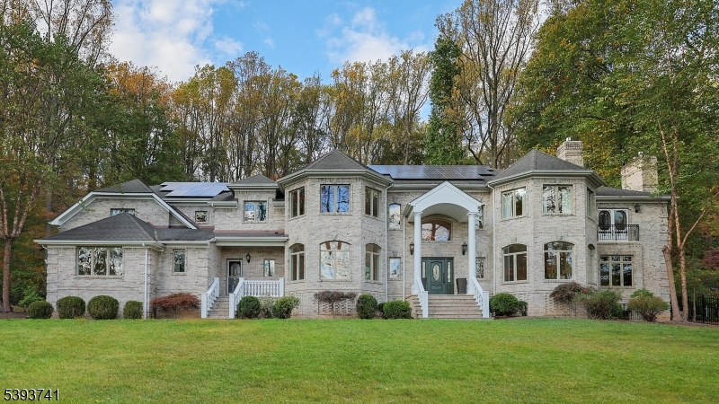 Elegant and timeless, this stately 16-room Watchung estate welcomes you with brick pillars, stone walls, and classic carriage lamps leading to a grand residence built with perfection in mind. Exceptional architectural design blends seamlessly with exquisite craftsmanship throughout, featuring Brazilian cherry floors, intricate multi-piece moldings, tray ceilings, and custom inlays that showcase remarkable attention to detail.The gourmet kitchen is a true centerpiece, cabinetry with intricate trim, gleaming granite countertops, imported Turkish marble tile, and top-of-the-line appliances, including a Sub-Zero refrigerator, ideal for both everyday living and entertaining. The home's gracious layout includes a dramatic two-story family room filled with natural light, a stunning butterfly staircase in the foyer, and multiple inviting paver patios that extend the living space outdoors.The luxurious primary suite is a private retreat, featuring a vaulted ceiling, a cozy fireplace sitting room, an expansive dressing area, and a spa-like bath designed for relaxation. Each of the six spacious bedrooms offers its own en suite bath. Set on a private and beautifully landscaped property, this residence combines elegance, sophistication, and superior quality in every detail. No expense was spared in crafting this extraordinary home that perfectly balances grandeur and warmth, truly a masterpiece of refined living.