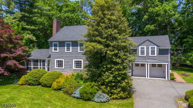 This Vernon Lee Colonial home welcomes one at the front brick porch and arched door entrance. A classic, timeless design with historic character, this home showcases built-in bookcases, corner cabinetry, a screened -in porch, woodburning fireplace, and back patio with an electric awning to shade sunnier days. The updated gourmet kitchen with center island and granite countertops, has all a chef could wish for with a coffee bar, working desk corner, stainless steel appliances, Whirlpool Refrigerator, and a Jen Air natural gas cooktop. There is also a LG dishwasher, Thermador double ovens, custom white cabinetry with ceramic backsplashes. The large breakfast area is open to the kitchen for conversations, overlooking a wall of windows facing an inviting backyard The laundry room is located off the kitchen for convenience with its own built-in ironing board, utility sink, washer, dryer, with plenty of storage for folding and hanging clothes. The formal dining and living rooms extend the open floor plan to a side screened-in porch with brick flooring and a ceiling fan for a cooler setting. The second floor brings one into a spacious bedroom or family room with a closet and an adjacent bonus room with two skylights. The hallway has a full bathroom and a pedestal sink, ceramic tiling and flooring. There are three additional bedrooms and a primary bedroom with a private bathroom with a custom glass shower & pedestal sink. The lower level has been renovated to have