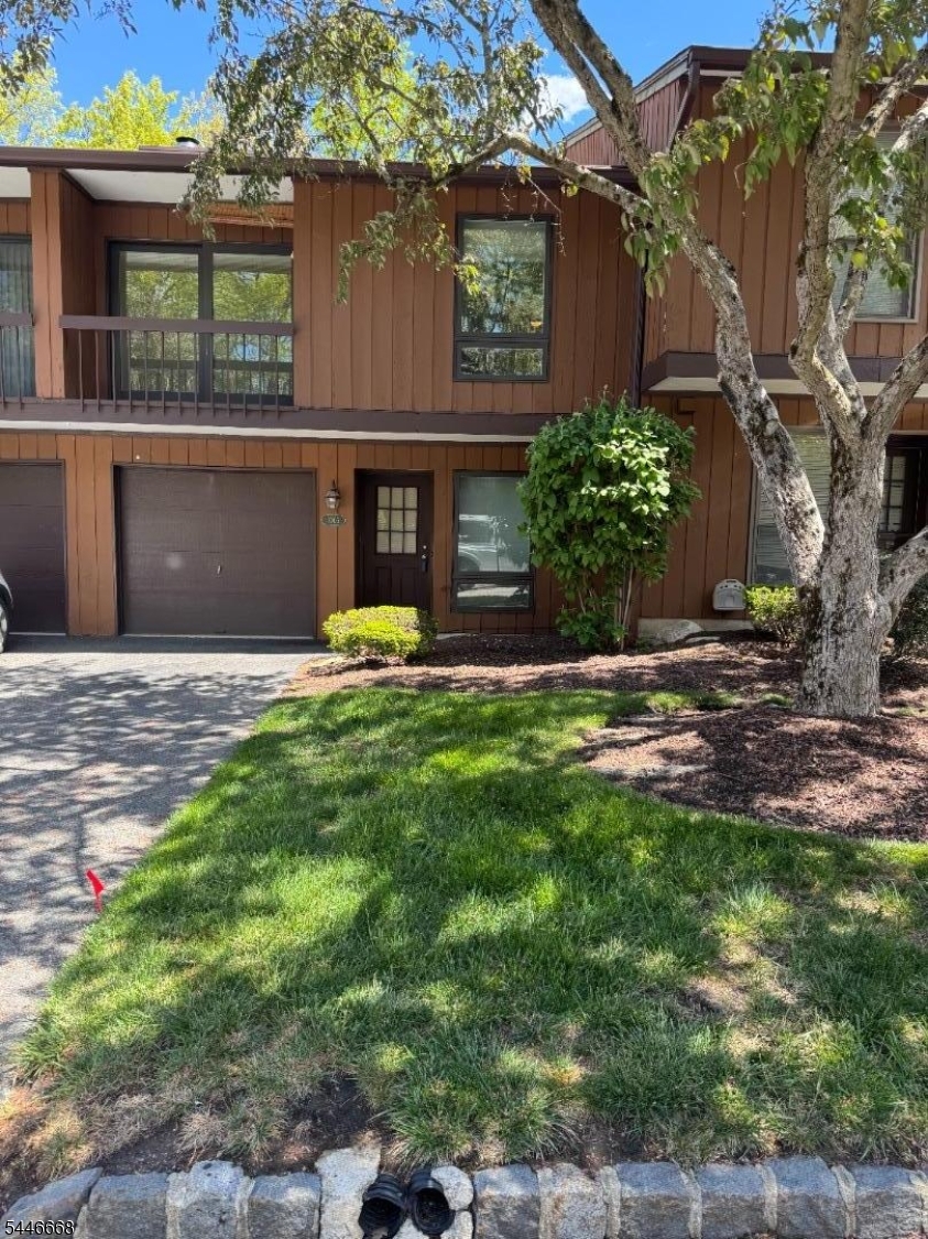 Welcome to desirable Overlook Village! This multilevel two-bedroom townhome offers an open-concept layout with spacious living and entertaining areas. The living room features sliders to a private balcony, while the family room boasts a cozy wood-burning fireplace and patio overlooking a peaceful wooded backyard. The primary bedroom includes its own private balcony and a full wall of closets. Additional highlights include a one-car garage and cul-de-sac location. Enjoy community amenities including a pool and tennis courts. This home is a must-see!