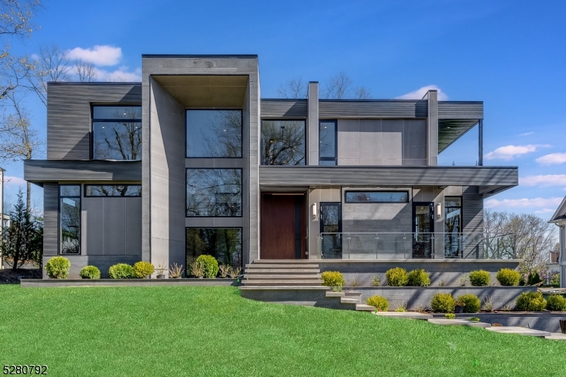 This new construction custom contemporary home is a masterpiece by local AHM architects.Set on nearly half an acre on the prestigious Hartshorn Dr.7800 sf of vast open floor plan & lofty ceilings creating multiple entertaining spaces.You're greeted by a soaring pivot front door opening into a 2 story foyer w/ chevron detail & floating staircase w/ custom glass railing.This home offers multiple outdoor spaces, an elevator to all three floors, wide plank white oak floors, multiple office options, walls of oversized German style modern windows, custom closets, convenient 2nd floor laundry room, private in-law suite w/ en suite bath, 10' ceilings & a show stopping kitchen w/ Wolf, Sub-Zero, Dacor & Miele appliances & sleek Dekton countertops.A hidden prep kitchen offers a entire second set of appliances.All bedrooms are generously sized w/ ensuites including the primary suite oasis w/ 2 custom walk-in closets, spa-like primary bath w/ radiant heated floors & private office/sitting room.Relax on a large deck w/ built-in outdoor kitchen & outdoor full bathroom with views of the level backyard w/ plenty of room for a pool.Lower walk-out level has maid's quarters w/ full bath, expansive rec room, wine room, theater & mudroom w/ access to 2.5-car garage w/ 2 EV chargers.This home is equipped w/ Automated Vantage Lighting System.House is pre-wired for speakers, shades, TV and audio for future home automation.300 amp electrical service.Close to highly rated Hartshorn School.