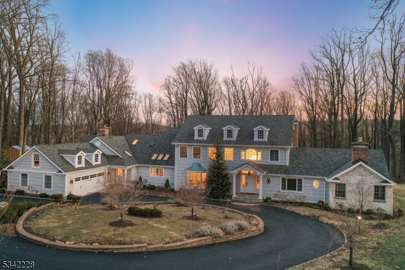 This distinguished Shingle-Style estate on the mountains has been meticulously renovated to offer an unparalleled living experience. Originally reimagined in 2018, this home seamlessly blends classic elegance with modern sophistication. With a rare indoor heated saltwater pool (46x24) and sauna, with French doors opening to a newly expanded sun terrace, now featuring a bespoke firepit, and the ultimate custom tree house. The gourmet kitchen- a masterpiece, boasting White Dolomite counters, a Wolfe range, pot filler, wine coolers, and marble backsplash. Sunlight streams through skylights, illuminating the expansive island and breakfast area. French doors lead to a stately portico and bluestone terrace with a gas-line grill. The gracious family room with a fireplace provides an inviting space, complemented by a formal dining room with a grand bay window and a living room adorned with a second fireplace. The primary suite on the first floor is a private sanctuary, featuring a travertine-clad spa bath, dual WIC, a gas fireplace, and a tray ceiling with custom illumination and its own private deck. Upstairs, four bedrooms with large closets including an en-suite. Accompanied by a second-floor laundry and a full-height attic awaiting transformation. Additional upgrades: commercial-grade dehumidifier/climate control for pool, custom Graber plantation shutters, new windows, high-efficiency gas fireplaces, a freshly paved driveway, and a newer roof ('20).  6-bed septic ('17),
