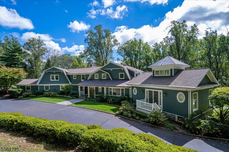 Wonderfully tranquil, this sprawling 5 bedroom, 7 full and 1 half bath home features recent updates surrounded by a gorgeous natural setting. A large two story foyer welcomes you to expansive first-floor living areas including a great room with vaulted ceilings and reclaimed wood accents and grand two-sided fireplace. The open concept chef's kitchen includes professional appliances, oversized center island, large dining and sitting areas with sweeping views of the property. A sun filled family room with full bath and office are located off the main living areas. A separate first floor wing includes two bedrooms, three full baths, laundry and changing rooms with access to the pool and patio, ideal for a nanny or guest wing or other flexible living situation. Located upstairs are the spacious, private primary suite with spa like bath, two additional en-suite bedrooms and second laundry. Outdoor living is impressive with rich green lawns, tranquil stream, heated swimming pool, outdoor shower and multiple porch and patio spaces for entertaining. A bonus to the property is a separate fieldstone car barn with 6 garage bays plus the 4 car attached garage, offering multi-functional space for a collector or enthusiast. A commercial grade generator provides peace of mind. Bordering Jockey Hollow National Park with nature trails and outdoor recreation, and conveniently located near downtown Morristown and Bernardsville shops, restaurants and culture and transportation to NYC