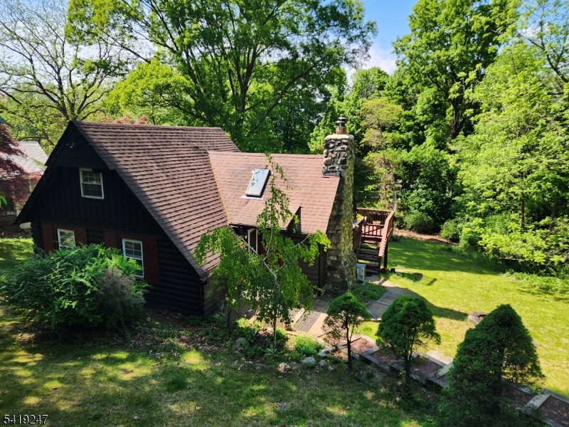 This charming original Crane-style cottage offers the perfect blend of comfort and character. Located in the sought-after Lake Mohawk community, this inviting home is ideal as a weekend retreat, year-round residence, or investment opportunity. Set on a peaceful property, this home welcomes you with a warm and rustic feel, featuring approximately 900 square feet of thoughtfully designed living space. Features include a gorgeous stone fireplace, vaulted ceilings, wood floors, and skylights. The easily accessible loft is used as a 2nd bedroom. Outside, the huge deck allows you enjoy the tranquility of nature with space to unwind, entertain, or simply take in the serene surroundings. Located just minutes from the lake, you'll have easy access to beaches, boating, dining, and year-round recreational activities. Whether you're looking to escape the hustle and bustle or invest in a desirable lake-area property, this cozy Sparta cabin is a rare find that delivers charm, convenience, and lifestyle all in one.