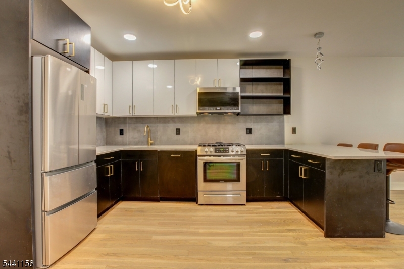 LOCATION, COMFORT & CONVENIENCE! Live in the heart of it all. Ideally located near NYC public transportation perfect for commuters and just 8 minutes from Port Authority. Enjoy close proximity to shopping, dining, and parks. This beautifully renovated apartment in a multi-family home features 2 bedrooms, office on the 3rd level and 2 full bathrooms, with laundry conveniently located in the unit and access to the backyard. The apartment has been completely renovated with a new kitchen, new bathrooms, new appliances, and new flooring, offering modern style and comfort throughout. This property offers the perfect balance of comfort, convenience, and urban living.