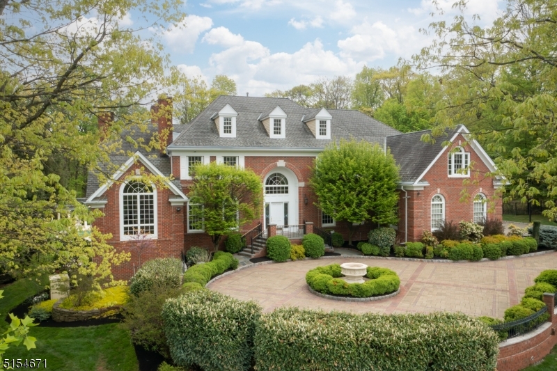 Elegant Full Brick Manor nestled in the hills of Warren on a quiet cul-de-sac, in one of the most sought-after neighborhoods. Impeccably maintained & well-appointed w/ many amenities to fulfill your work from home, staycation, and entertaining needs. The backyard paradise offers an ideal place to unwind and recharge alongside the custom heated pool & spa, while listening to the soothing sounds of the koi ponds waterfalls. The property's lush & mature landscaping provide the ultimate level of privacy and tranquility after a long day. A distinctive 1st floor office features pocket doors, built-in cabinetry, and a spiral staircase that leads to the primary suite's sitting room. The grand chef's kitchen boasts an expansive prep island, designer appliances, and an oversized breakfast nook that overlooks the backyard oasis- with direct access to the outdoor BBQ. The 1st floor guest suite is complete with a full bath & WIC. Dual staircases lead to the upper level, which is highlighted by a bright & airy primary suite - with vaulted ceilings, sitting room w/ gas fireplace, dual WICs, and a spa like ensuite. The remaining 4 upper level BRs each have a Jack & Jill shared bath. The walk-out lower level makes entertaining a breeze with its direct access to the pool area, full bath, wet bar, gym space, and media room. Whole home generator; electric deer fence; central vac; lightning rods on roof; tankless water system; indoor/outdoor surround sound system and much more.
