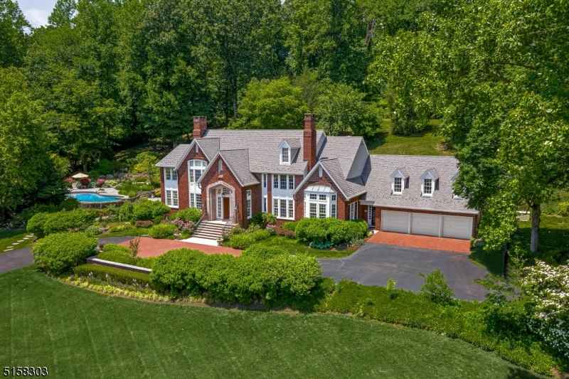 This striking updated custom residence offers beautiful finishes & luxurious amenities at every turn. Set on 5+ magnificent, landscaped acres atop Bernardsville Mountain, this well-appointed home is a model for sophistication & style. Hardwood floors, detailed architectural moldings and millwork, coffered ceilings, and transomed windows prevail throughout the light-filled interior. The newly renovated designer kitchen with breakfast room features white maple cabinetry, marble and granite countertops, and professional appliances. The spacious primary suite is an oasis that includes a sitting room with gas fireplace, a sumptuous, updated radiant heated bath & large custom outfitted walk-in closet. The meticulously landscaped gated property includes an infinity pool, spa, bluestone patios, koi pond, waterfall, and gardens, making this an ideal home for relaxing & entertaining. Smart Home technology allows for ease to control lighting, audio, and outside amenities. Shopping, dining & recreational opportunities abound in the area as well as equestrian facilities and nationally ranked golf courses. Close proximity to the NJ Transit train, and major highways make this the perfect location.