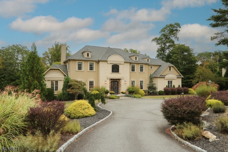 This majestic 5 BR, 6000 sq ft manor, which includes 1200 sq ft of partially finished WO basement is the Builder's Own Personal Estate - designed and constructed as Builder's dream home, situated on 2.62 Private Acres! Located on a serene cul-de-sac, this carefully and thoughtfully designed, open-concept home pays attention to every detail. Very easy and convenient highway and mass transit access, attends highly ranked Mountain Lakes High School with nearby parks and recreation. The stunning facade of stucco block design & natural stone with superior details are certain to impress! This home is equipped with a whole house generator and house fan. The designer kitchen with massive 10.5 foot granite island, separate dining area with natural stone arches and unique gas fireplace set in natural stone is your ideal gathering spot for large parties or intimate gatherings. You will love and appreciate the one-of-a-kind bathroom setup for multiple occupants! The convenience of the 2nd floor laundry plus additional laundry access in the basement lends itself to live-in house guests or just the elimination of overflow. The 10/12 foot ceilings, 12 foot marble, custom family room fireplace, Cumaru Brazilian hardwood and marble floors, extensive trim details and finished walk-out basement with 10 foot ceilings exudes elegance and luxury at every turn. You will discover many delights around every corner!