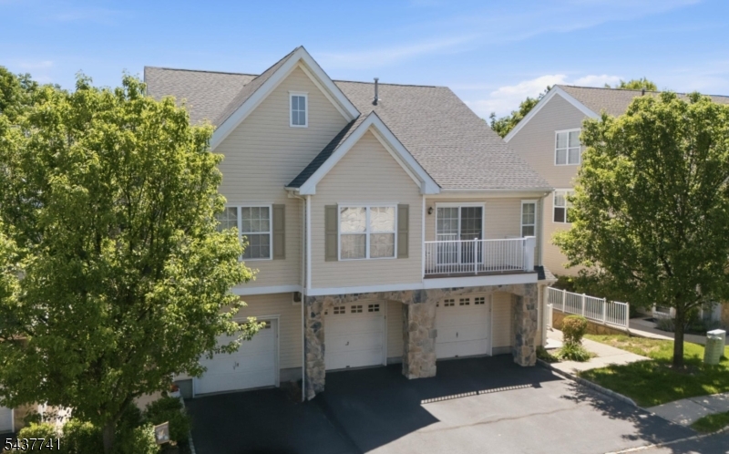 Welcome to this beautifully maintained, sun-drenched end-unit townhome in the desirable Highlands community. Featuring a convenient main-level entrance & direct garage access, this 2/3-BR, 3.5-bath home offers single-family convenience & a spacious, open floor plan. The main floor features brand-new flooring, fresh paint, new lighting, & a stunning gas fireplace w/ a custom mantle. The upgraded kitchen features granite countertops, newer stainless appliances, and a comfortable breakfast bar. Upstairs, the primary suite offers vaulted ceilings, serene, wooded views, a walk-in with custom California Closets, and an en-suite bath with a soaking tub. This level also offers an additional bedroom and full bath. A real gamechanger is the fully renovated light filled walk-out lower level; featuring a third full bath, fresh paint, new flooring, and 2 cedar closets. This is the perfect space for a gym, office, third bedroom or all three! Through the sliders you'll find a sweet little patio and grassy area for quiet relaxation. Behind the scenes, enjoy peace of mind with Ecobee smart thermostats, a reverse osmosis water filter, Keyless door locks, a new hot water heater, a water softener, and new lighting & outlets. A standout feature of the complex is the fantastic community pool, making summer days a breeze. Residents also enjoy a pet-friendly policy, & a prime location near direct NYC bus and major highways for an easy commute. Incredibly inviting and completely turn-key!