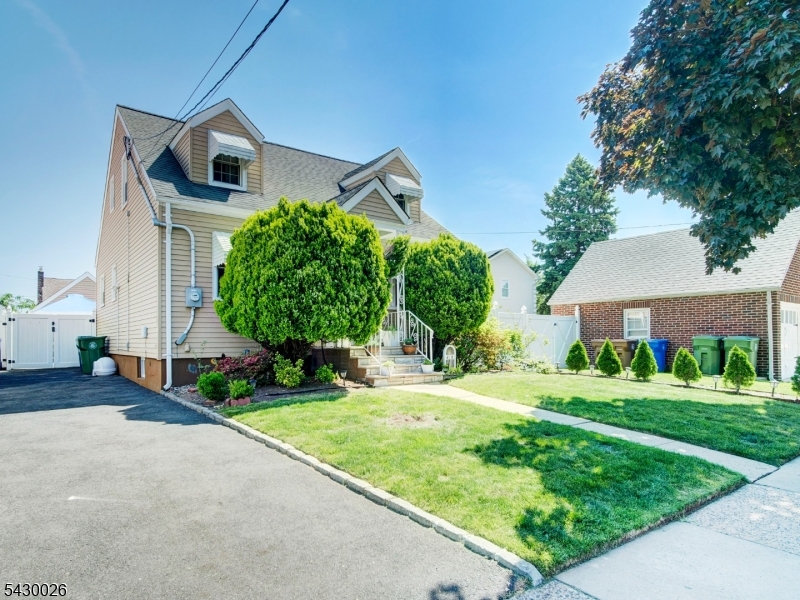Welcome to this beautifully maintained 3-bedroom, 2.5-bathroom Cape Cod in a highly desirable Linden neighborhood. This property perfectly blends classic residential charm with smart, high-end modern upgrades throughout. The main level features a bright, open living and dining area with pristine hardwood floors and elegant archways. The updated kitchen comes fully equipped with sleek granite countertops, crisp white cabinetry, a stylish tile backsplash, and stainless steel appliances. Also on the main floor is a spacious bedroom sitting adjacent to a standout, newly remodeled full bathroom. This bath features premium marble-style tile work, custom recessed shelving, and a frameless glass walk-in rainfall shower.Upstairs offers two additional comfortable bedrooms and a convenient half bath. The exterior is designed for easy maintenance and outdoor enjoyment, featuring a long paved driveway, a detached 1-car garage, and a fully fenced, private backyard with a lush lawn perfect for relaxing or entertaining. Located just minutes from local schools, parks, dining, and major transportation. This home is completely turn-key and ready for its next owner. Schedule your showing today.