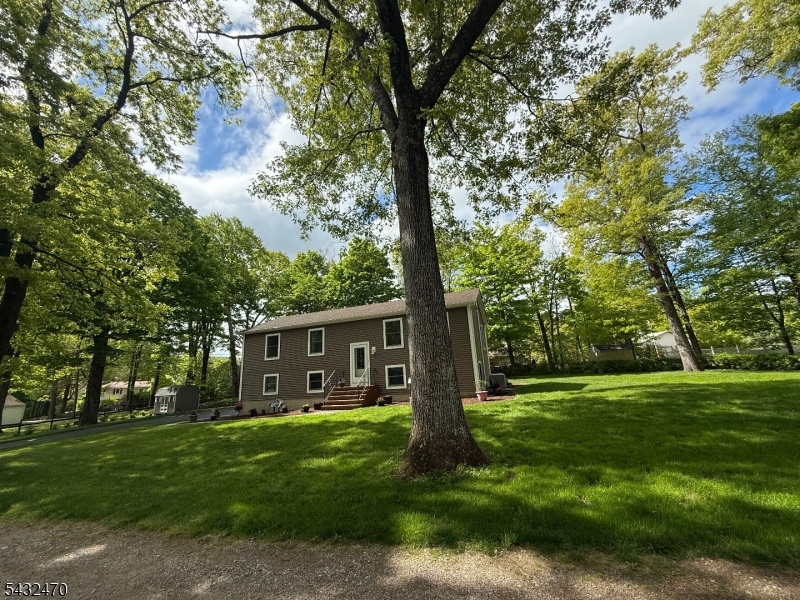 Nestled in the heart of West Milford, this beautifully maintained raised ranch offers the perfect blend of comfort, space, and convenience. Situated on a generous .59-acre lot just off Ridge Road and moments from the center of town, this inviting single-family home features 3 bedrooms and 2 full bathrooms designed for comfortable everyday living. Step inside to discover a warm and cozy atmosphere with a thoughtfully designed layout ideal for both relaxing and entertaining. The home boasts a partial-finished basement offering additional living space perfect for a recreation room, home office, gym, or guest area. A 2-car garage provides ample storage and convenience year-round.Lovingly cared for and exceptionally well kept, this property offers the privacy of a large lot while still being close to shopping, dining, schools, and local amenities. Plus only 10 minutes from Greenwood Lake! Whether you're looking for peaceful suburban living or extra space to grow, this charming home delivers it all.