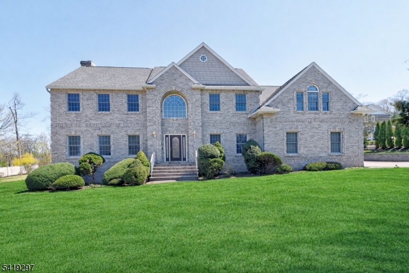 Builder's Own Custom Center Hall Colonial  built to the highest standards, this stunning custom Colonial rests on a 2/3-acre lot within walking distance to top-rated schools and NYC train access   offering the perfect blend of suburban tranquility and city convenience. Exceptional quality and craftsmanship are evident throughout this spacious 5-bedrooms, 3.5-bath home. The first floor features soaring 9-foot ceilings, while the sunken primary suite impresses with a dramatic 10-foot cathedral ceiling and a gracious sitting area. Rich hardwood floors flow throughout, complemented by porcelain tile in the kitchen and tumbled marble in the bathrooms. The gourmet kitchen is the heart of the home, boasting custom cherry cabinetry, granite countertops, and a center island with sink   perfect for everyday living and effortless entertaining. Lower Level ready for finishing to your liking for additional square footage. Top-Rated Schools and Shopping. Situated just minutes from Major Highways Route 46, Route 80, and Route 280 offering an easy commute to NYC and EWR.