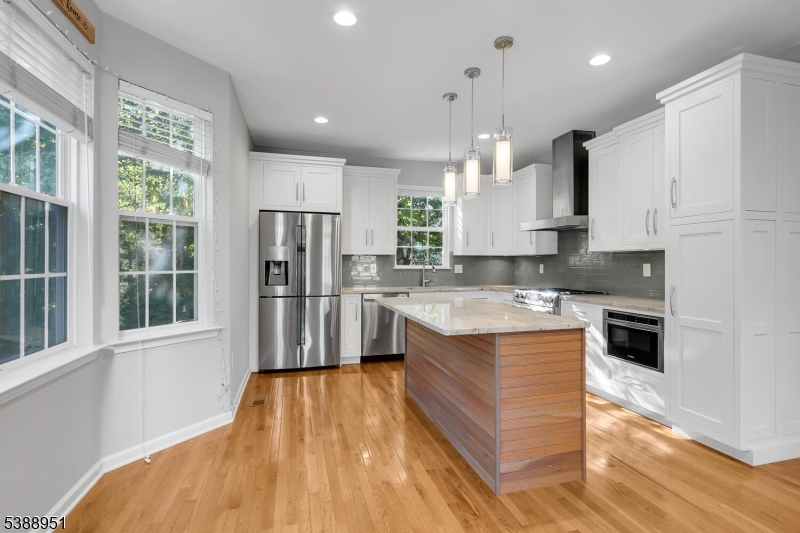 Welcome to this beautifully updated Filmore model on a desirable corner lot in the Liberty Ridge section of The Hills, Basking Ridge. This spacious 5-bedroom, 3.5-bath single-family home is filled with natural light and enhanced by hardwood floors and recessed lighting throughout.The main level features a living room, family room with an electric fireplace, a private study with custom built-in bookshelves, and an updated kitchen with a center island and newer appliances. Primary and guest bathrooms are fully renovated with custom built-in closets.Finished basement expands the living space with hardwood floors, Bose speakers, a full bath, and a versatile bonus room - perfect for a home gym, playroom, or guest space. Additional updates include a newer HVAC (2022), new Water Heater, EV charger ready. As part of The Hills, residents enjoy access to exceptional amenities including pools, clubhouse, tennis and Pickleball courts, playgrounds, walking paths, and a fitness center. Paired with top-rated schools and a prime location, easy access to 287 and 78, this well-appointed home is available for immediate occupancy an ideal rental opportunity in one of Basking Ridge's most sought-after communities.