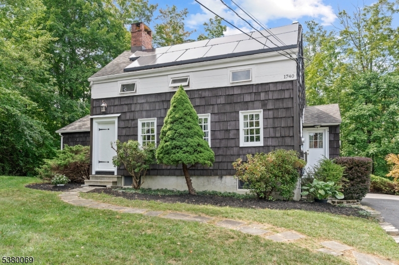 A example of 18th century architecture, thoughtfully relocated to its current site in the late 1990s. Despite modern updates and tasteful additions over the years. The home retains original character and timeless appeal. As you approach the home, you are greeted by its unique three eyebrow windows, a nod to 18th century craftmanship. Original stone fireplace in the living room and wide plank wood floors in the dining room. With four bedrooms and two bathrooms, the layout is both functional and comfortable for modern living. Spacious family room with built-ins and sliding door that opens to a private rear deck perfect for outdoor entertaining or quiet moments in the serene backyard. This historic gem is conveniently located within easy reach of Main Street, schools, shopping, and commuter routes, allowing both a peaceful retreat and connected lifestyle. 3 Bedroom Septic.