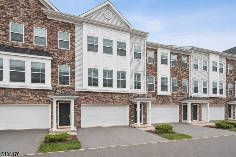 Enjoy a stress-free luxury lifestyle! Live the lifestyle you've been dreaming of in this spacious townhome nestled within The Collection at Morristown, close to everything Morristown has to offer. Enjoy easy access to vibrant downtown dining, shopping, parks, cultural attractions, and convenient NJ Transit direct train service to NYC. Distinctive features of this unit include Hunter Douglas custom shutters, custom ceiling fans, main-level hardwood flooring, and an open, airy layout designed for comfortable everyday living and entertaining. The living room, framed by a wall of large windows, flows seamlessly into the formal dining area and stylish eat-in kitchen, complete with granite counters, stainless steel appliances, ample cabinetry, and a breakfast bar. A convenient powder room is tucked just off the kitchen, while the large balcony extends the living space outdoors, perfect for relaxing, dining al fresco, or enjoying fresh air at the end of the day The upper level encompasses the primary bedroom with a walk-in closet and en-suite bathroom with a dual-sink vanity and oversized glass shower, along with two additional bedrooms, a full hall bathroom, and a convenient second floor washer/dryer. The finished basement level has a large recreation room, a full bathroom, and a walkout to the back yard. Move right in and enjoy luxurious, low-maintenance living in this unbeatable location! This property has a 24-year tax abatement, ensuring low taxes for years to come!