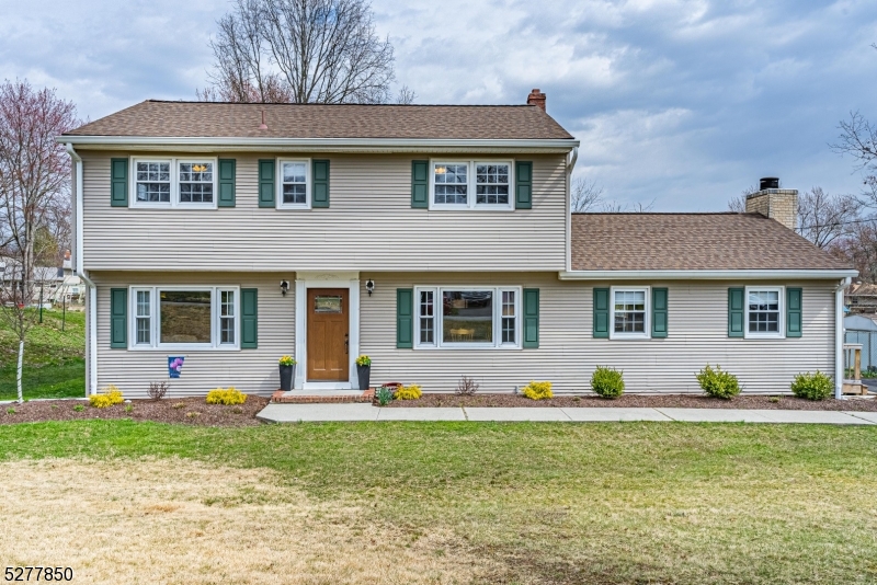This Spectacular & Beautifully Appointed Center Hall Colonial is nestled in the desirable Troy Hills Section. Over half an acre with over 2000 square feet, this flowing, classic layout is great for entertaining or everyday living.. Foyer welcomes you in &  is bookended by a formal living room & dining room. Both boast large picture windows. Tons of natural light. Eat in kitchen w/granite countertops & stainless steel appliances opens to the large family room w/ wood burning fireplace. Convenient powder room & laundry. Gorgeous HW flooring, moldings & wainscoting. Upstairs 4 generous sized bedrooms & two full baths include a primary suite w/ en-suite & stall shower. Finished basement- bonus living w/rec room & den. Partially unfinished space w/workshop and provides storage along with attic & shed. Stunning Backyard Oasis- Perfect for Entertaining & Relaxation! Large Deck & Pool. Completely fenced in a large, level yard. Situated in a great location with easy access to all life's conveniences- close proximity to NYC-Direct train station, bus to Port Authority, shopping & parks. Walk to top-rated Parsippany schools. Easy access to major hwys. Meticulously maintained, shows true pride of ownership. Don't miss it!