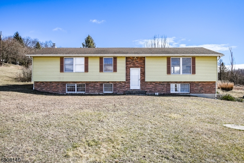 This is the starter home, easy fixer upper blank slate you've been waiting for.  This large bilevel is in great condition.  It features laminate floors and double sliding glass doors on the first floor.  Chimney is ready to accept new wood or pellet stove. Tons of room for entertaining downstairs plus full bath and potential office space.  Inlaw suite potential. Upstairs feels massive with an open kitchen dining room area adjacent to living room with picture windows overlooking the breathtaking country side views that go on for miles. Could be opened up more to make this house feel huge. 3 generous sized bedrooms and full bath upstairs. Exterior and interior are in great shape and clean bring your vision to put your finishing touches.