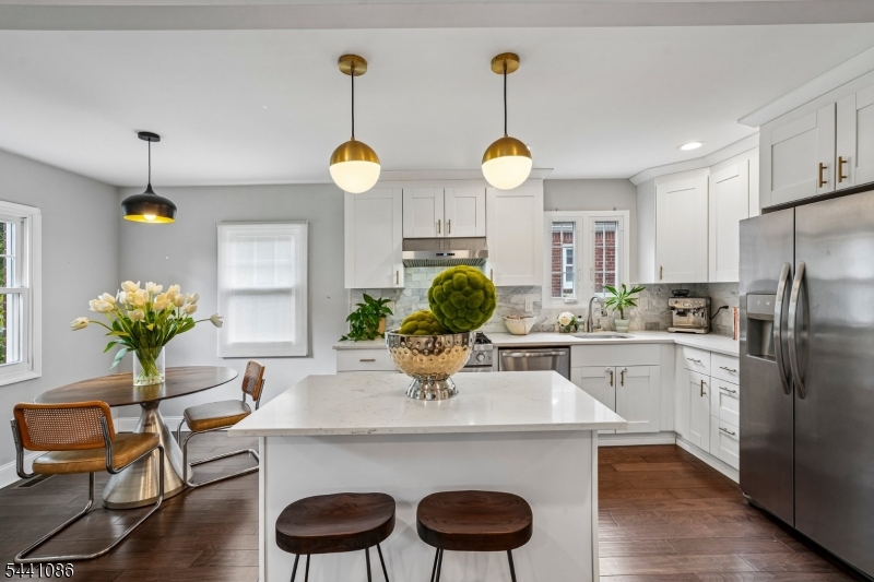 Step into a home that feels instantly welcoming. This beautifully updated 4BR/2BA Teaneck residence sits on a quiet private street and offers the perfect blend of warmth, character, and modern comfort. Renovated in 2019, it features soaring 9.5' ceilings, sun-filled rooms, and a stunning kitchen with both a cozy eat-in nook and a sit-at island- a true gathering space for slow mornings and lively evenings.The inviting layout flows to a serene, enclosed yard with a porch overlooking peaceful views, creating an everyday retreat. Upstairs, spacious bedrooms include a primary suite with a generous walk-in closet, plus the convenience of a 2nd-floor washer/dryer. A 6-year-old roof, 2-zone HVAC, EV-charger hookup, and an open approximate 8 ceiling basement add comfort, efficiency, and room to grow.All of this in an unbeatable location: 5 minutes to I-95/Route 4, walking distance to the NYC/Port Authority express bus, parks, houses of worship, and just blocks from Holy Name Hospital.A home filled with light, warmth, and the kind of spaces that make everyday living feel special.