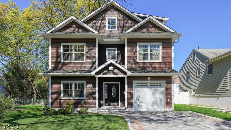 Stunning newer construction (2023) offering modern design, quality craftsmanship, and exceptional functionality, set on a quiet residential street in Cranford. This beautifully built 5-bedroom, 4.5-bath home features a light-filled, open layout designed for today's lifestyle. A dramatic foyer creates an impressive entry and sets the tone for the home's airy design. The first floor offers a spacious living room, formal dining room, and an impressive designer kitchen with high-end cabinetry, quartz countertops, center island, and stainless steel appliances. The kitchen opens  to a large family room ideal for everyday living and entertaining. A convenient powder room and garage access complete the main level. The second floor features 4 generously sized bedrooms, including a luxurious primary suite, along with well-appointed baths. The third floor offers a fifth bedroom or dedicated home office, fully outfitted with custom shelving and built-in office furniture all included creating a private work-from-home space. A  spacious media room and full bath complete the third floor. Built with today's buyer in mind, the home includes central air, energy-efficient systems, and quality finishes throughout, delivering true move-in ease. The exterior offers a private fenced yard, perfect for relaxing or entertaining, along with off-street parking on the belgian block driveway. Ideally located near parks, schools, and highways. A rare opportunity for modern living.