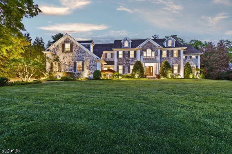 MAGNIFICENT CEDAR SHINGLE COLONIAL * PRESTIGIOUS OLD SHORT HILLS * Majestically perched atop 0.75 acres, this 9051sqft home has both the pedigree & elegance of Old Short Hills - replete w/ beautiful architectural details, design & craftsmanship - and constructed for modern living. Travel up the front path to find a front-to-back, two-story foyer, sweeping staircase, 10ft ceilings, 4 fireplaces & wood-paneled library/office. Entertain by the living room fireplace, host in the elegant dining room w/ adjoining Butler's Pantry, repose in the sunroom or unwind in the open kitchen/family room. The state-of-the-art kitchen has custom cabinetry, SS appliances (Viking, Sub-Zero, Meile), center island w/ quartz counters & bar seating, breakfast room w/ window banquet, a command center desk area, mudroom & access to 3-car garage (Tesla charger). Head upstairs via one of two staircases to find 6 BRs, 5 FullBths, a sitting room, homework area & laundry room. The luxurious Primary Suite has its own wing w/ fireplace in bedroom, 2 WICs & a spa-like bath w/ two vanities, custom marble floor, soaking tub & over-sized glass shower. The LL has a huge rec room, amazing exercise room, full bath & game room. Step outside onto the Bluestone patio - nestled amid lush grounds & perennial gardens - an outstanding entertainment space (room for a pool!) Close to downtown Millburn, top-rated schools & SH trains to NYC. This spectacular estate is both an architectural masterpiece & a private sanctuary.