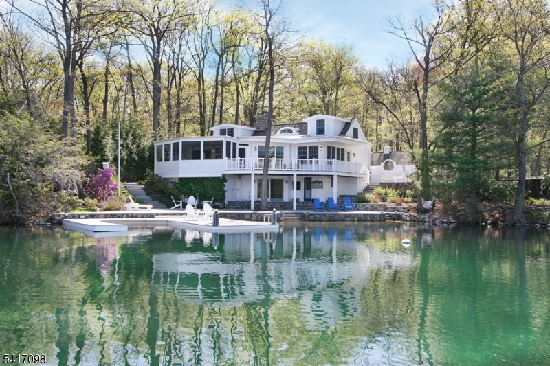 Discover the perfect blend of serenity and sophistication at 140 Lake End Road, nestled in the  private enclave of Lake End Corporation at beautiful Green Pond. This stunning lakefront home is one of just 66 properties where residents enjoy direct access to the pristine, spring-fed waters of Green Pond and breathtaking lake and mountain views.Renovated with exquisite taste and custom designer touches throughout, this lovely 5+ bedroom, 3-bath home features a comfortable open floor plan that effortlessly accommodates guests. Special highlights include two cozy fireplaces, a relaxing screened porch, a spacious patio, a bunk room and a full walk-out lower level that opens directly to the lake. Outside, you'll find a private year-round dock perfect for boating and swimming, plus a detached 4-car garage for ample storage and convenience.Whether you're seeking a year-round residence or a peaceful weekend retreat, this exceptional property offers an unparalleled lakefront lifestyle in one of New Jersey's most cherished private communities. Don't miss your opportunity to make 140 Lake End Road your own slice of paradise at Green Pond! Home being sold furnished. The beauty, tranquility and protected environment of Green Pond, New Jersey's cleanest lake, makes the location of this distinctive community ideal for year-round living or a convenient weekend retreat.  Nestled in the Morris County foothills and centered around a 2.5 mile long natural