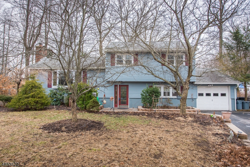 Welcome to 21 Lake Dr., this 4 bed 2 full bath Split level home is waiting for it's next owner(s).The ground level  has one  bedroom, full bath and sitting room with sliders to backyard and access to the garage.The first floor has an updated kitchen with silestone counters, custom oak cabinets and recessed lighting. The 16x18  Great room was added in 2009, it has hw floors and french doors that lead to the in ground heated pool with hot tub and waterfall. Living room w/ wood burning fireplace and formal dining. Second floor has three generous size bedrooms along with the additional bathroom. The basement has a game room and a rec room. Lake views complete this not to be missed home.