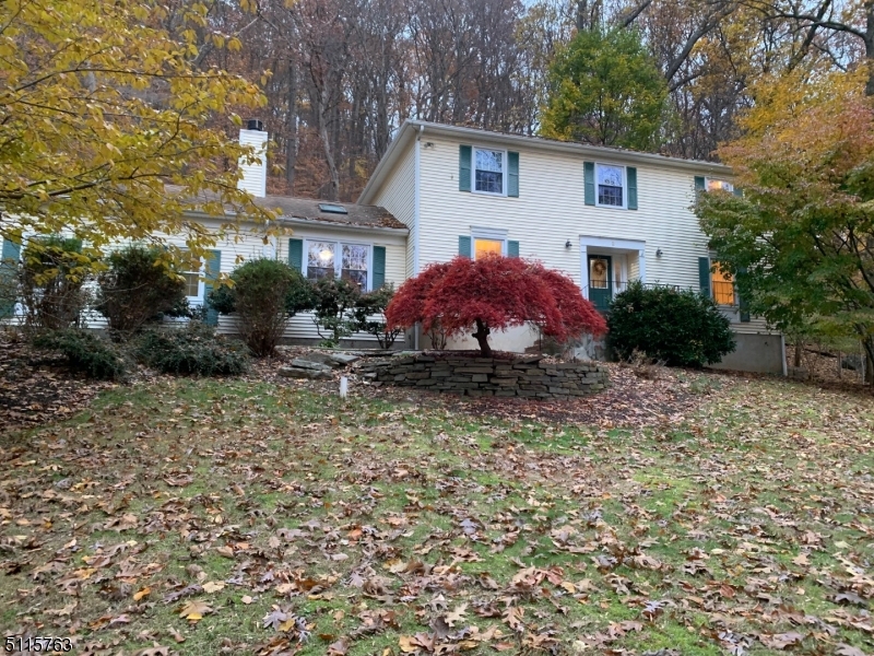 Peace and Privacy!! This 4 bedroom, 2.1 bath Colonial sits on 1.18 acres, much of it wooded, no home behind you, no home next to you on one side, affording maximum privacy! The homes property runs TO THE CORNER leaving an AWESOME OPPORTUNITY to clear and add yard space if needed. The 1st floor features a formal living room, formal dining room & family room w/fireplace and deck access. The family room leads to a spacious eat in kitchen w/stainless steel appliances and large pantry. The laundry & powder room finish off the first floor space. The 2nd. floor includes a spacious Owner's Suite with bath + WIC plus 3 additional  bdrms & hall bath. The basement is finished to include an office and rec space in addition to workshop and storage areas. Award winning schools plus close to parks, restaurants and shops! Commuters can access trains plus routes 46, 80 and 206 in just minutes!