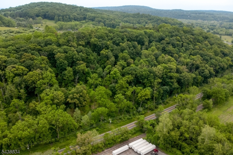 13.54 acre wooded parcel overlooking the Delaware River with scenic views, privacy, and endless possibilities. The sloping terrain rises from the road through mature trees, creating an ideal setting for a custom home, private retreat, or weekend getaway. Enjoy the beauty and tranquility of nature just minutes from charming river towns, local amenities, and commuter routes. *If using GPS: Property is across from 551 Riegelsville Milford Rd, Milford, NJ 08848