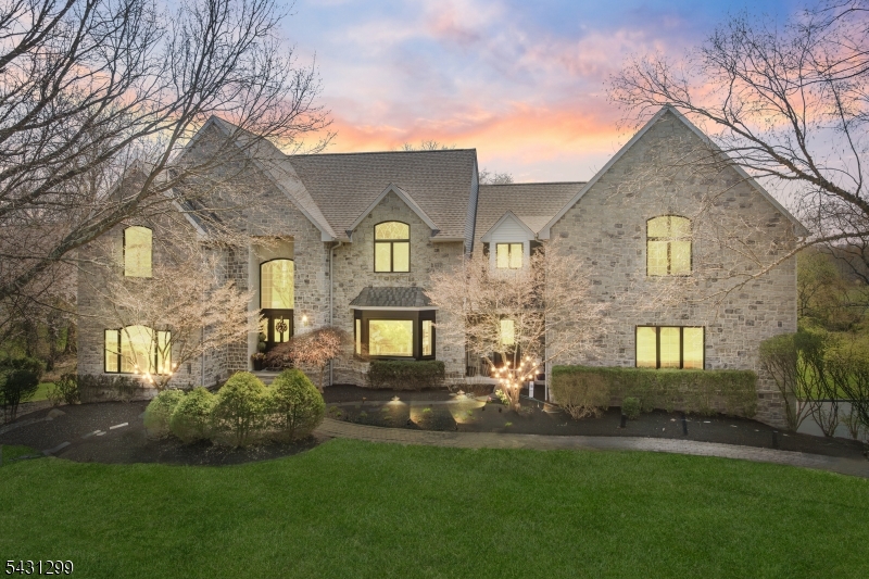 This EXCEPTIONAL Stone-Front Center Hall Colonial tucked away on a private cul-de-sac in Belle Mead blends timeless elegance with dramatic timber-frame architecture, soaring cathedral ceilings, exposed beams, and stunning wooded views. Filled with natural light, the expansive layout offers oversized living spaces, a private first-floor office, loft retreat, and flexible accommodations ideal for entertaining or extended living. The sunken living room with wet bar and the beautifully updated eat-in kitchen with granite countertops, stainless steel appliances, and center island create inviting gathering spaces throughout. Brand-new carpeting enhances the home's move-in-ready appeal while preserving its warmth and architectural character. An expansive Trex deck overlooks preserved open space and serene woods, while the walkout basement with garage access and plumbing rough-in for a future bath offers endless potential. Additional highlights include radiant heating, rear-facing solar panels, expansive front and rear yards, and a truly one-of-a-kind setting that combines privacy, comfort, and architectural distinction.