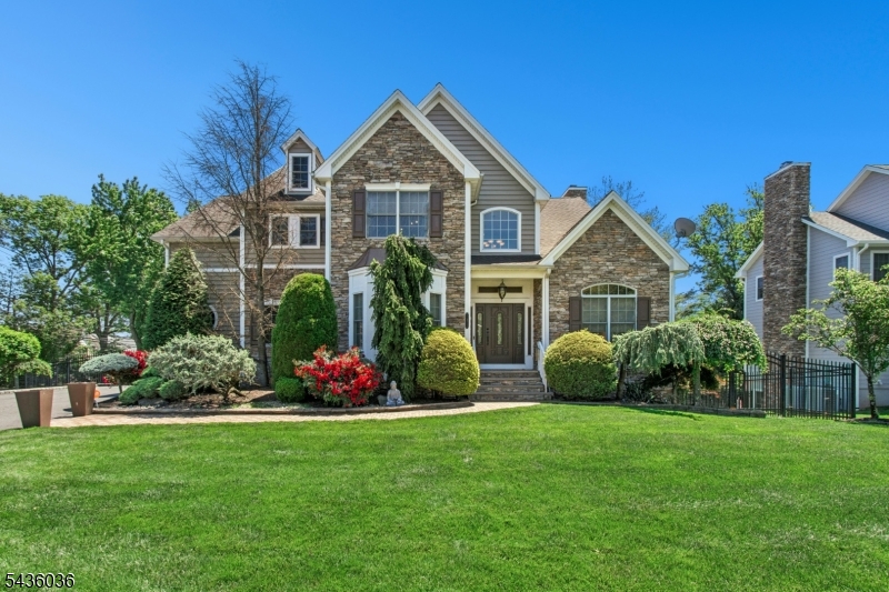 #1 GRAND custom Colonial designed for luxury living in one of Clark's most desirable neighborhoods. A fully finished WALK-OUT basement w features over 8-ft ceilings, a full second kitchen w. large island, dining, recreation, office, exercise room, full bath & extensive custom storage; Front entrance to enjoy a dramatic two-story foyer w. angled oak staircase & wrought-iron banister, elegant custom moldings, coffered ceilings, chair rail detailing & two gas fireplaces. The chef's kitchen features commercial-grade appliances, double wall ovens, granite counters, breakfast bar, butler's pantry, and sunlit breakfast area overlooking the family room. Show-stopping floor-to-ceiling stone fireplace w. raised hearth & custom mantel creates a warm luxury focal point in the family room; The luxurious primary suite includes a sitting area, gas fireplace, spa-inspired bath w. heated bidet, Bluetooth-enabled fan/audio system, and Every bedroom features custom walk-in closets, including a private ensuite bedroom ideal for guests; Beautifully landscaped w. a cultured stone exterior, Italian-finish paver walkway, oversized 2-car garage & rare 10-car driveway, impressive curb appeal; Enjoy two separate outdoor living areas- an elevated deck and private patio- surrounded by custom landscaping; upgrades include Brand New furnace & AC Home theater,  Vivint security,  Motorized awnings,  2026 prepaid lawn care, mosquito; HVAC maintenance & sprinkler winterization.