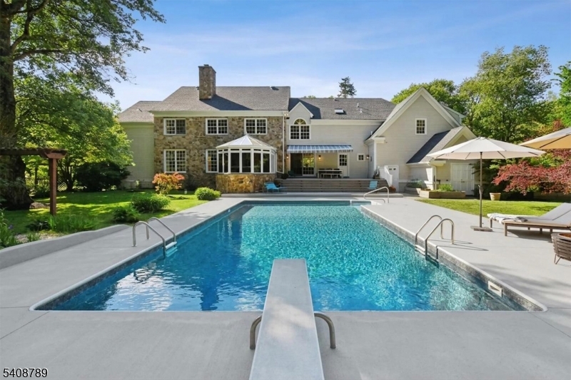 This updated, elegant hobby farm is nestled at the end of a cul-de-sac in one of Far Hills' most desirable neighborhoods in a secluded setting bordering Natirar park. Generously-sized rooms, an open floor plan, high ceilings on all 3 levels of finished space, and plentiful doors and windows overlooking balconies, patios, and decks provide a natural visual and physical flow between interior spaces and the spectacular setting. 4 bedrooms with en suite bathrooms as well as extra spaces for home offices/sitting rooms/gyms provide a floor plan that accommodates the evolution of its owner's needs. Finished basement includes large recreation room, full bathroom, and 2 gym/office/craft rooms. A freestanding, renovated (2021) artist's studio with loft and beautifully-renovated (2025) 1 bedroom groom's quarters with full bathroom, kitchen, laundry, and heat/AC facilitate enjoyment of the property as a vacation home and/or hobby farm. Equestrian/livestock facilities include 7 stall barn with feed and tack rooms and large hay loft and tractor/equipment storage garage, outdoor riding arena, 4 lush pastures with newer post-and-board fencing and run-in sheds, and 2 stonedust all-weather turnouts. Additional updates to property since 2020 include geothermal heating/cooling in main house (2024), roof (2026), renovation of bathrooms, interior (2026) and exterior (2023) paint, renovation of patios/decks, and more! Easy access to shopping, public/private schools, and commuting highways/trains.