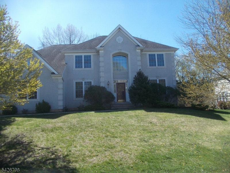 Welcome to 11 Shadow Hill Way, a magnificent two-story colonial-style single-family home located in the prestigious Hidden Hills neighborhood of Washington Township (Long Valley/Hackettstown). Situated on a pristine 0.58-acre lot, this 5-bedroom, 3.5-bath residence offers approximately 3,588 sq ft of living space. The grand two-story foyer welcomes you into a light-filled floor plan featuring generously sized rooms, hardwood flooring, and more. The main level boasts a formal living room, a formal dining room, and a dramatic family room with a fireplace, ideal for entertaining. The spacious kitchen has easy access to the deck. The upper level features four generously sized bedrooms, including a primary suite with a walk-in closet and private bath. Exterior features include a charming front facade, a 2-car attached garage and a peaceful, landscaped backyard with a deck and patio for outdoor enjoyment. Located within the top-rated Washington Township school district, this home is just minutes from shopping, dining, and scenic local parks. Basement is large and finished with a wet bar for entertaining. Do not miss the opportunity to own this beautiful home.