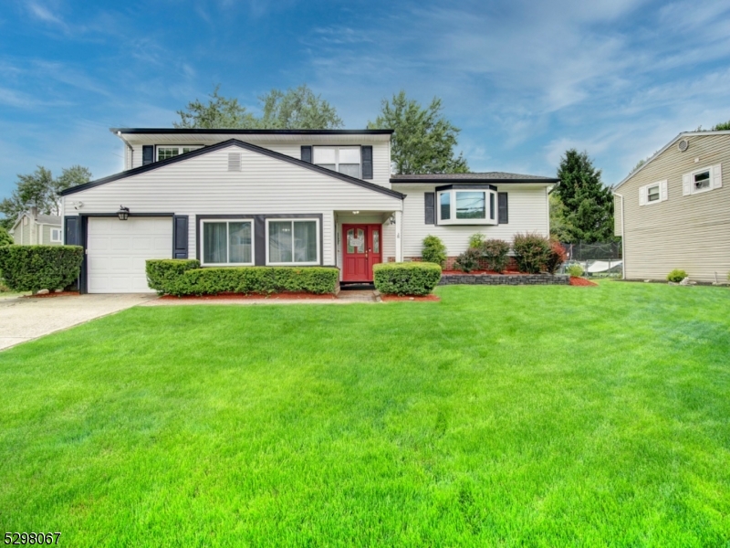 Presenting, this well maintained, 4 bedroom, 2.5 bath home that is every commuters dream, and it's conveniently located just one block away from the elementary school. The home's main level features a central kitchen design where everything is easily accessible, stainless steel appliances and sliding doors that lead to entertaining sized gazebo-style deck which overlooks a beautiful treelined back yard. Spacious living & dining rooms with lovely wood floors & recessed lighting, beautifully renovated full bathrooms, both with heated floors and three spacious  bedrooms on main level also with wood flooring. The large fourth bedroom is located on the ground level. The first floor also has a large foyer and den which accesses the garage, gas oven & sliders that leads to outdoor patio/yard. A half bath and laundry room with newer stackable washer & dryer, complete the ground level. PUBLIC UTILITIES HERE!