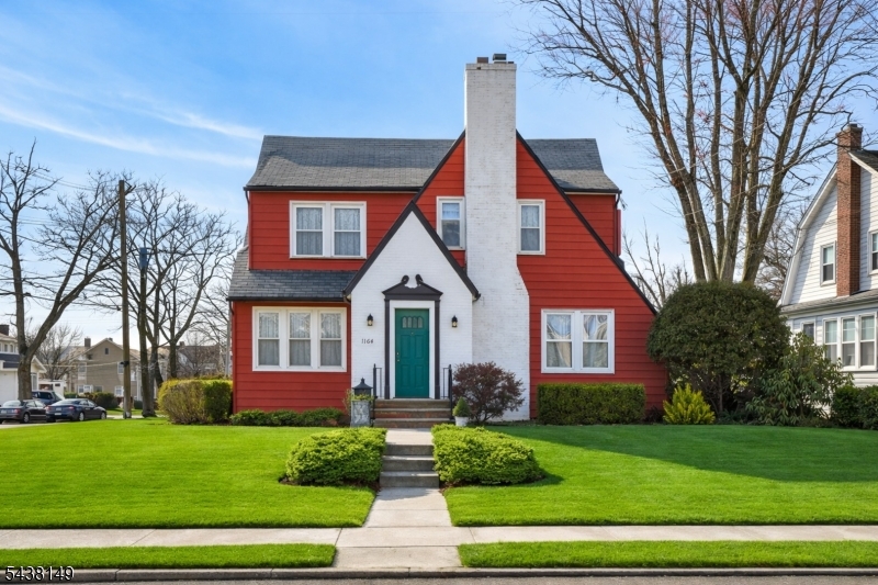 Welcome to this stunning 4-bedroom Tudor-style Colonial, ideally situated on a picturesque tree-lined street near the South Plainfield border. Built in 1931, this beautifully maintained home offers a thoughtfully designed 2,210 sq ft floorplan that blends classic charm with everyday functionality. The spacious eat-in kitchen features tile flooring, GE appliances including a gas 4-burner cooktop with Nutone exterior exhaust, a GE dishwasher, & a stainless-steel side-by-side Whirlpool refrigerator with water and ice dispenser. Additional highlights include a stainless-steel sink, recessed lighting, & a ceiling fan. A convenient 1st-flr powder room adds to the home's practicality. Perfect for entertaining, the home offers a formal dining room adorned w/ dental & crown molding, a bright & airy den/family room, & a relaxing 3-season enclosed porch. The inviting living room showcases a marble-front wood-burning fireplace w/ wood mantel, detailed molding, and wood flooring with elegant ribbon inlay. Upstairs, you'll find a generously sized primary bedroom, three additional bedrooms, and a charming original tiled hallway bath w/ separate tub & shower. The finished basement expands your living space w/ a large recreation area featuring a dry bar, a half bath w/ subway-tiled shower, plus dedicated storage, laundry, & utility rooms. Fireplace sold "As Is" condition; there are no know issues.