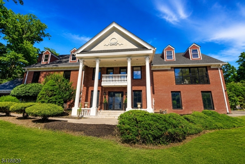 Welcome to this fully renovated grand brick colonial in Upper Saddle River's sought-after Northern Highlands school district. Set on a tree-lined street with serene pond views, this 5-bedroom, 4 full and 1 half bath residence offers over 5,696 sq ft of refined living space, plus an unfinished third level with 1,600+ sq ft of high-ceiling recreational potential. Recently transformed with major luxury upgrades, the home features a new roof, HVAC, septic, full-house filtration, custom windows and doors, frameless garage doors, 6-inch white oak floors, high-end appliances, custom millwork, new bathrooms, wet bar, wine rack, and designer finishes throughout. A dramatic foyer and grand staircase lead to formal living and dining rooms, private study, spacious family room with fireplace, beautifully appointed kitchen, and bright breakfast area. Custom full-opening sliding glass doors create seamless indoor-outdoor flow to the patio, grounds, and pond views.Upstairs, 5 bedrooms include a luxurious primary suite with vaulted ceilings, walk-in closet, spa-like bath, steam shower, soaking tub, and private retreat feel. The third level offers rare flexibility for a theater, golf simulator, gym, lounge, wet bar, or recreation space. Complete with level grounds, landscape design ready, 3-car garage, whole-house generator, and convenient access to shops, restaurants, Route 17, and NYC transportation, this renovated estate delivers space, quality, and lifestyle in one exceptional home!