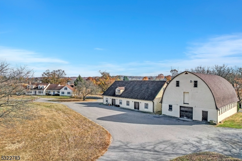 Welcome to Black River Farm located in the heart of Hunterdon County horse country on 64.5 pristine acres. For the discriminating equestrian buyer, this property has everything! There are 65 stalls in total-main barn has 30 insulated 12x12 rubber matted stalls w/automatic waterers, automatic temp.-controlled fans, water purification and softener system, 4 wash stalls with hot and cold water, feed room, tack room, peek a boo stall windows, office, laundry, bathroom, hay storage, heated and air-conditioned lounge, blacksmith area and more! To add to the list is a 95x275 indoor arena with custom footing, 5-acre Grand Prix Field and additional outdoor rings and 21 fenced paddocks. 7 fully occupied rental units, two additional barns, solar and more make this property a must see for the discerning buyer. The main house has been updated and lovingly maintained. Come fall in love with this elegant colonial cape with 4 large bedrooms, 3.5 baths, with a fabulous designer kitchen, large formal dining room w/hand painted wallpaper, huge family room w/vaulted ceilings, sunken game room, office and more. The list goes on and on! This property has it all!