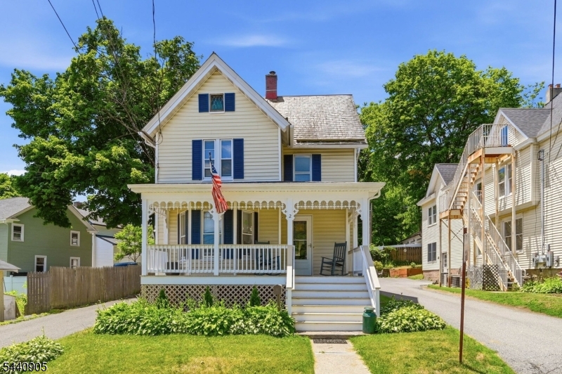 Filled with charm and character, this turnkey Victorian Colonial offers the perfect blend of original details and modern updates in a convenient location. Situated on a sidewalk-lined street in the heart of Newton, this home is just minutes from downtown shops, restaurants, and major retail amenities. A covered front porch welcomes you inside where you'll find original hardwood floors, moldings, and timeless architectural details throughout. The first floor offers a spacious living room, formal dining room, and a flexible den that could serve as a home office, playroom, or additional bedroom. The updated half bath off the den features crisp white wainscoting and classic style. The renovated kitchen has granite countertops, stainless steel appliances, tiled backsplash, LVP flooring, abundant counter space, and a coffee bar with butcher block counters and open shelving. The adjoining breakfast room offers a breakfast bar and pantry, while a door off the kitchen leads directly to the rear deck. Upstairs are four bedrooms, including one with a huge WIC, along with a full bath featuring a tub/shower combination and charming wainscoting. Outside, enjoy a covered front porch, rear deck, fenced backyard, and an oversized detached garage/barn offering excellent storage, workshop space, or room for hobbies. Public water, public sewer, natural gas, and all the benefits of living in Newton, including free full-day preschool and a complimentary membership to the town pool.
