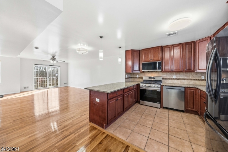 Welcome to this beautifully maintained townhome, built in 2013 and thoughtfully updated for today?s lifestyle. Recently painted and featuring refinished hardwood floors, this home offers a clean, modern feel with nothing to do but move right in. The ground level provides incredible flexibility, featuring direct access to the garage, a laundry area, and an additional room with a full bath?perfect for guests, a home office, or a private retreat. The main living level showcases an open floor plan designed for both everyday living and entertaining. The kitchen offers a convenient breakfast bar that flows seamlessly into the dining area and spacious living room, with access to a private balcony?ideal for enjoying your morning coffee or unwinding at the end of the day. Upstairs, you?ll find two generously sized bedrooms and two full baths, including a primary suite with its own private bath, creating a comfortable and functional layout.Ideally located close to NYC bus transportation and just a short drive to the train station, this home is perfect for commuters seeking both convenience and style
