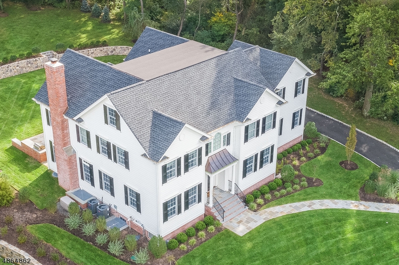 Exquisite 2017 construction built by renowned builder W.P. Lloyd. This 7 bedroom,  5.1 bath home with a perfect floor plan sits on .61 acres in the desirable Rolling Hill section of Chatham. Custom finishings with a transitional flair make this home stand out from the rest. A custom white kitchen opens to breakfast room & family room with fireplace & coffered ceiling. A 1st floor bed, full bath, butler's pantry, mudroom & 3 car garage complete 1st level. 5 beds & 3 full baths are on 2nd level.  The large master suite has 2 walk-in closets, a sitting area & full bath. The finished basement has a large rec room, bedroom, full bath, exercise room & storage. 3rd floor is plumbed for bathroom & wired for electric to be easily finished. Outside is a bluestone patio with built-in grill, private level yard.