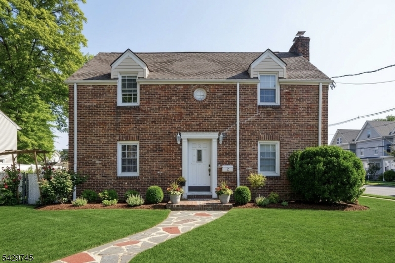 This timeless brick Colonial sits on a spacious corner lot along a picturesque, tree-lined street. Offering 5 bedrooms and 2 full bathrooms, this home blends classic charm with everyday functionality. Features include central air, a finished basement with a dedicated laundry area, and a private home office perfect for today's work-from-home lifestyle. The main level showcases a well-proportioned living room, formal dining room, and a spacious eat-in kitchen designed for both comfort and convenience. Step outside to a large backyard, ideal for entertaining, relaxing, or creating your own outdoor oasis. Additional highlights include a two-car garage and an unbeatable location close to transportation, schools, restaurants, and shopping. A true gem you don't want to miss!