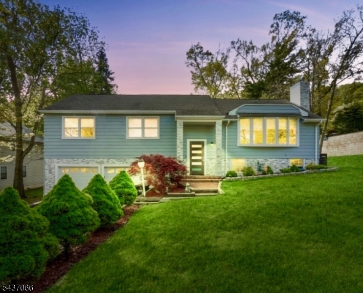 Welcome to this beautifully renovated home in the highly desirable community of Mountainside. This exceptional residence offers 3 bedrooms and 3 full bathrooms with an open-concept layout designed for comfortable living and effortless entertaining. Upon entering, you are greeted by a stunning modern ring chandelier, refinished hardwood floors, and LED lighting throughout. The custom kitchen features quartz countertops, a center island, stainless steel appliances, a 5-burner stove, and opens seamlessly to the dining area. The spacious primary suite has been reconfigured to include a luxurious custom walk-in closet with built-in shelving and a dedicated office area, along with a beautifully updated en-suite bath featuring dual vanities and a glass-enclosed shower. All bathrooms have been tastefully renovated with modern finishes.The ground level expands the living space with a warm and inviting family room featuring a wood-burning fireplace, new vinyl flooring, a full bathroom, and a laundry room. Additional updates include a newer furnace and central air conditioning compressor.Step outside to your private backyard retreat showcasing a striking stone fa ade, Gunite in-ground pool, custom deck, brand-new paver patio, and a fully fenced yard perfect for relaxing or entertaining. Conveniently located near parks, schools, shopping, dining, and major transportation routes, this move-in-ready home offers the perfect blend of style, comfort, and convenience.